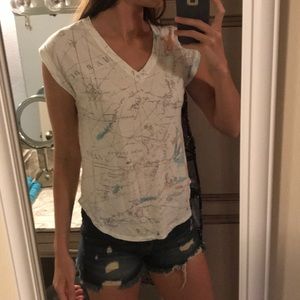 Cute sleeveless white top with tropical images.